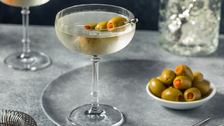 martini with bowl of olives