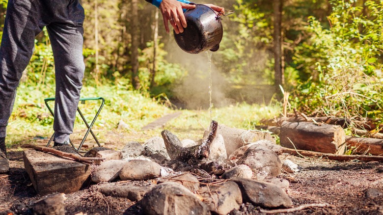 putting out campfire with water