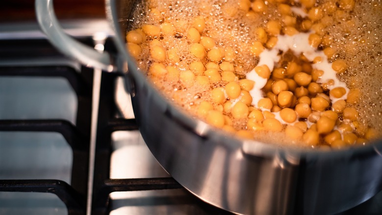 Chickpeas boiling in a pot on a stove