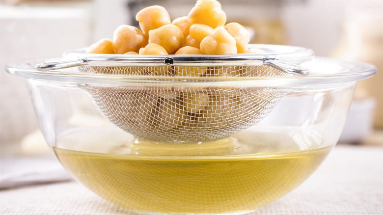 Bowl of aquafaba and strained chikpeas