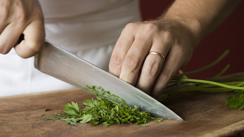 Chef chopping herbs