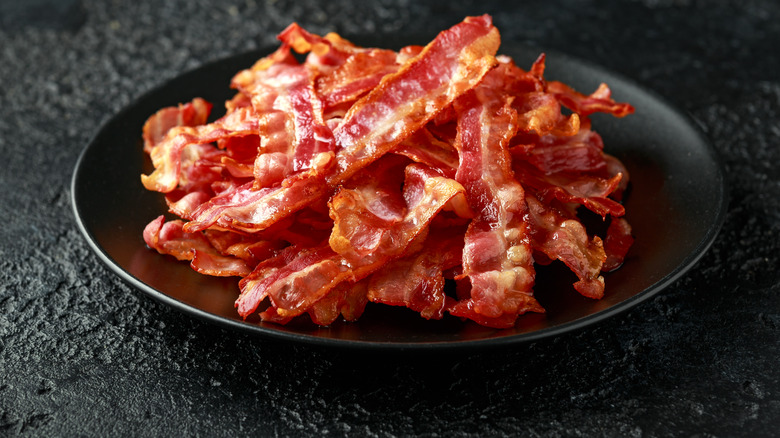 A plate full of cooked bacon