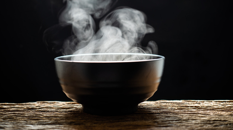 Steaming bowl on wooden table