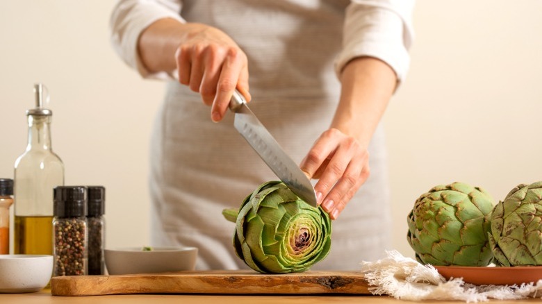 Slicing fresh artichokes open