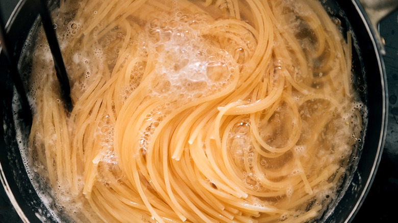 Noodles cooking in water