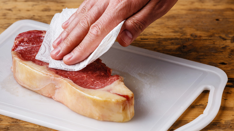 Steak patted with paper towel