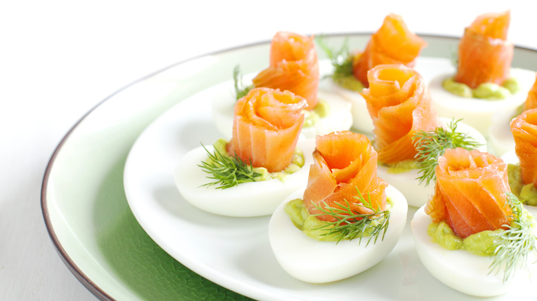 Salmon rosettes on deviled eggs