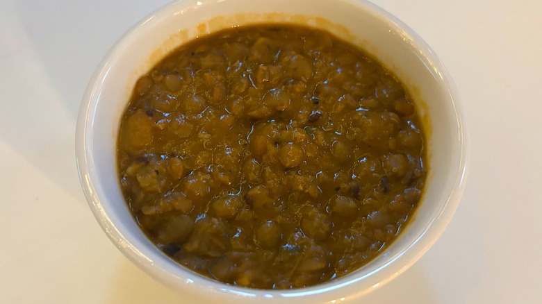 cup of trader joes lentil soup with ancient grains on white table