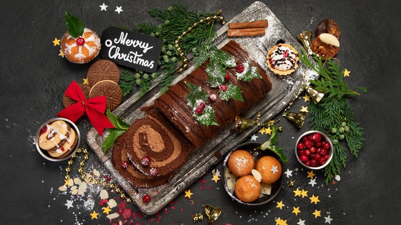 Overhead view of chocolate Christmas cake with festive decorations