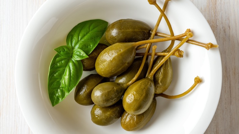 Caperberries in white bowl