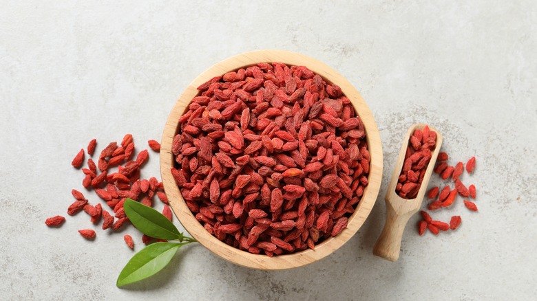 Dried goji berries in a wooden bowl