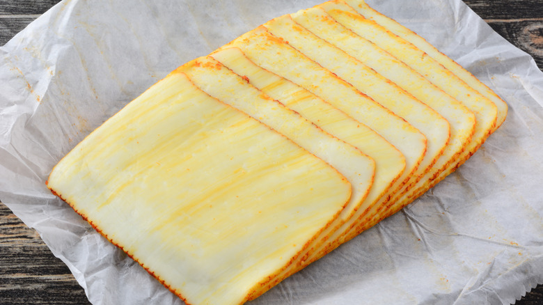 Muenster cheese slices on paper