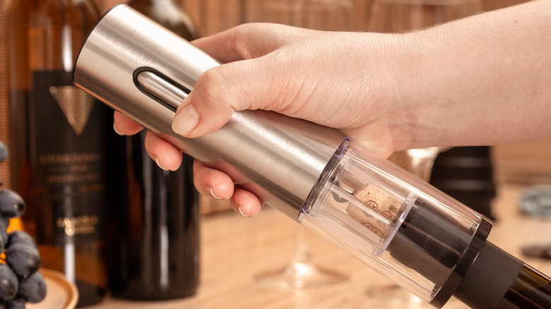 Hand holding electric corkscrew