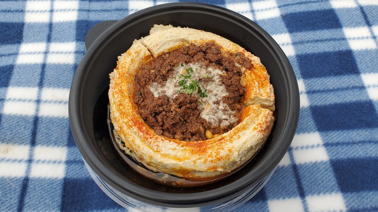 Hummus topped with meat