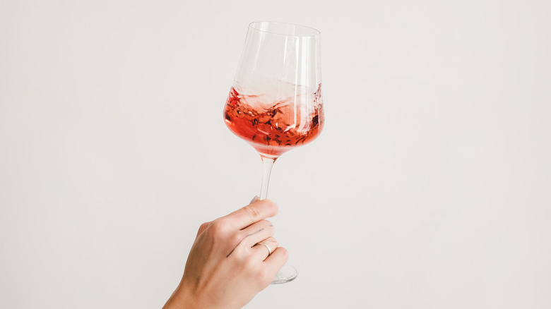 hand holding wine glass