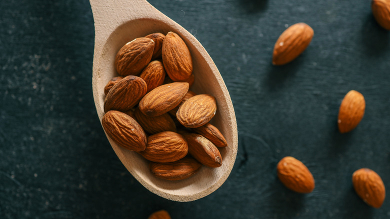Almonds on a wooden spoon