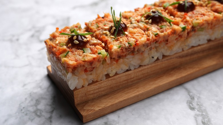 Pieces of oshizushi sushi on wooden platter