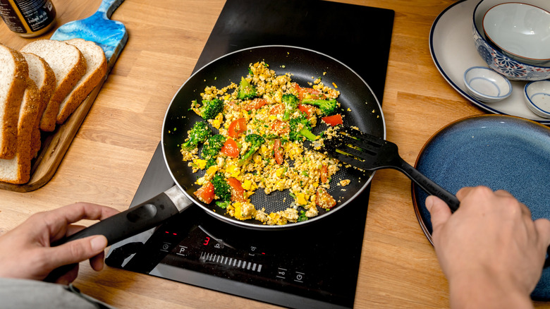 Cooking tofu scramble in pan on induction stovetop