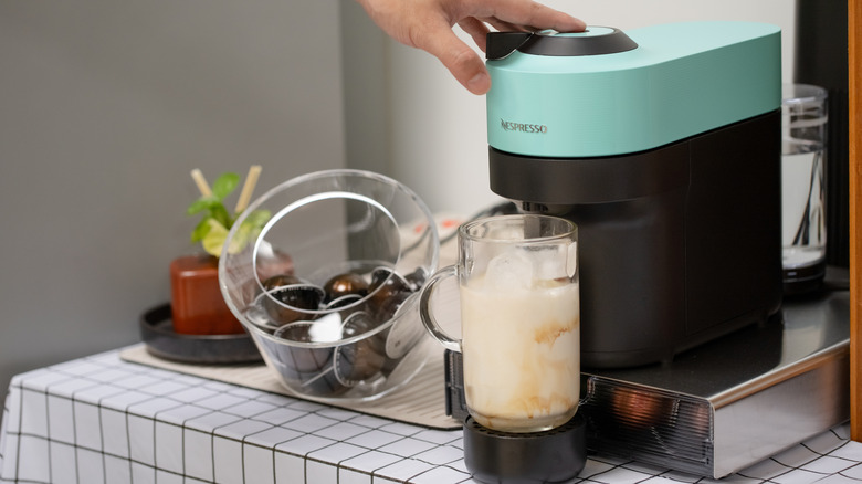 Blue Nespresso machine brewing ice coffee