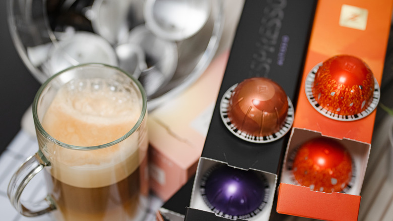 Variety of Nespresso pods with cup of cofee