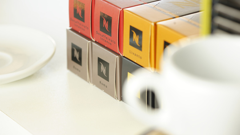 Shot of various Nespresso sleeves behind coffee cup