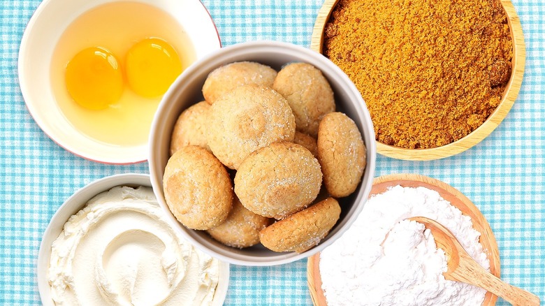 Sugar cookies surrounded by dough ingredients