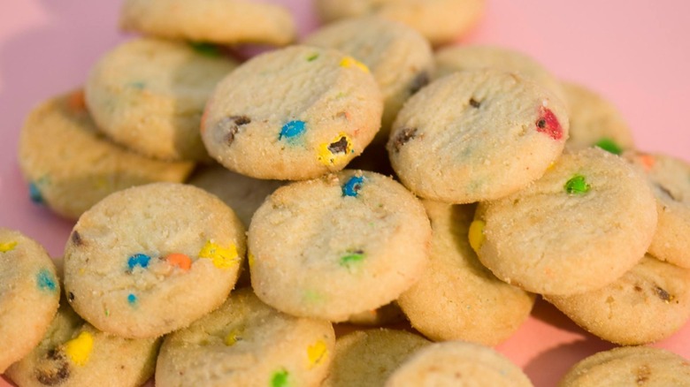 mini candy cookies pink background