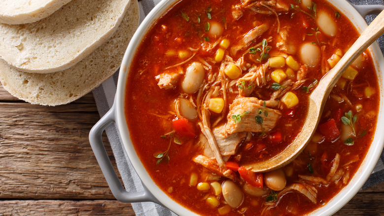 red meaty stew with bread