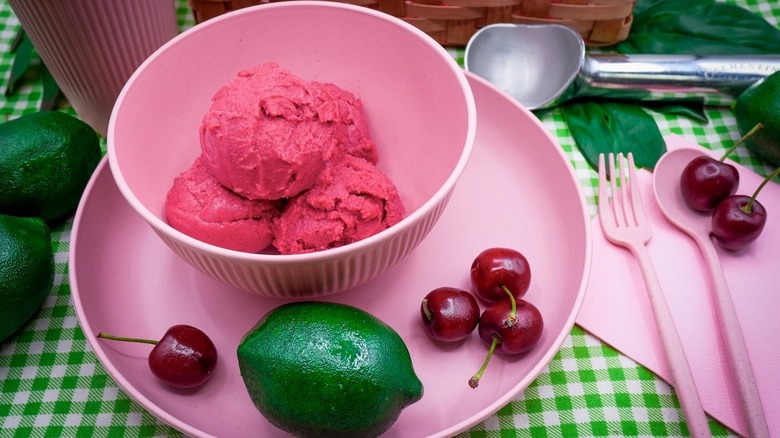 Ice cream bowl, cherries, and lime