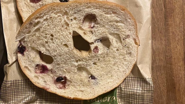 sliced blueberry bagel on bag