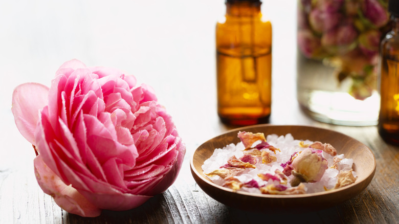 A rose and rose water on table