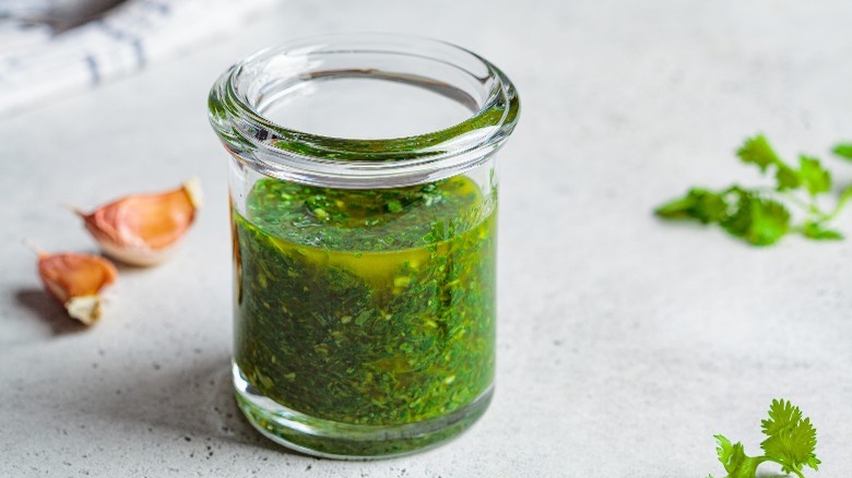 A jar of chimichurri sauce