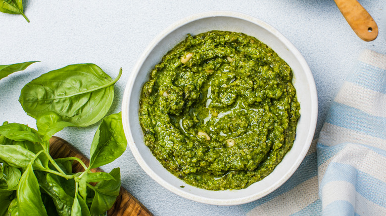 Pesto in bowl with fresh basil