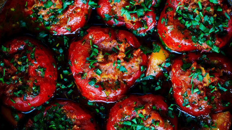 Stuffed red bell peppers with herbs viewed from above