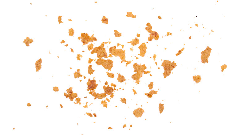 Pile of bread crumbs on white background