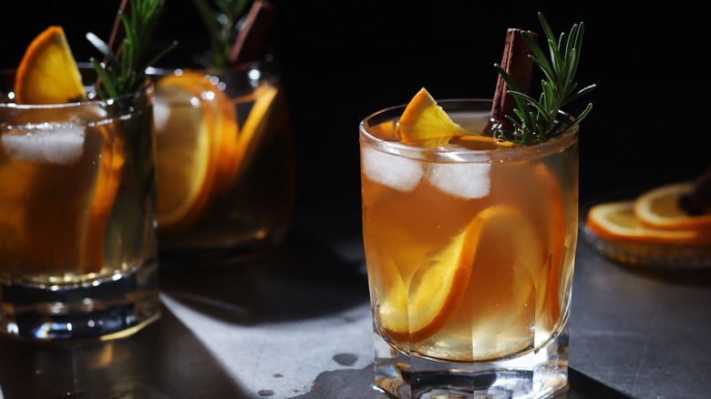 orange and herb garnished cocktails