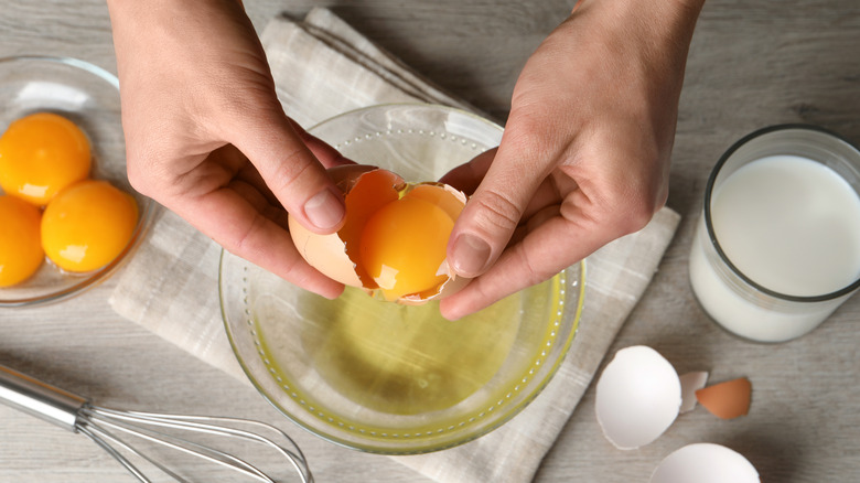 Person separating egg whites from yolks