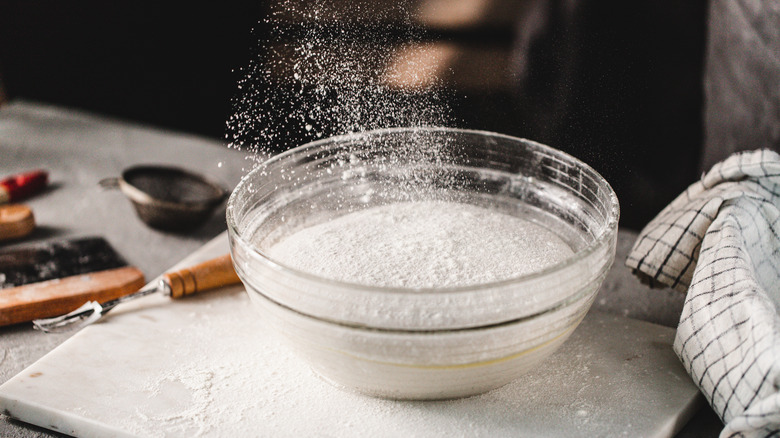 Flour sprinkling into bowl