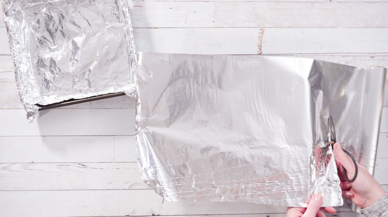 Putting aluminum foil on pan