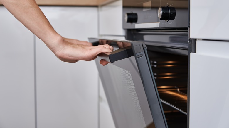 hand opening oven door