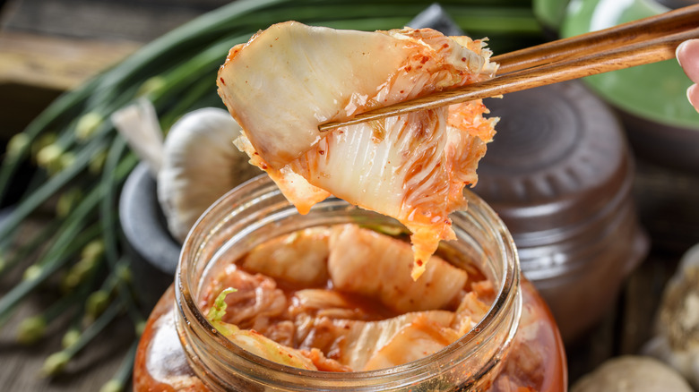 chopsticks holding kimchi