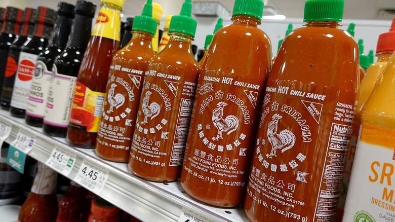 Bottles of sriracha on store shelf