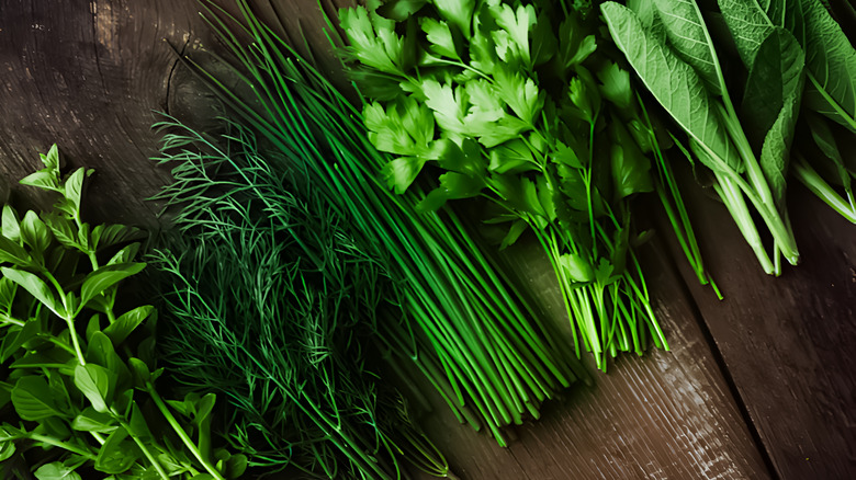 Freshly clipped herbs on wooden background