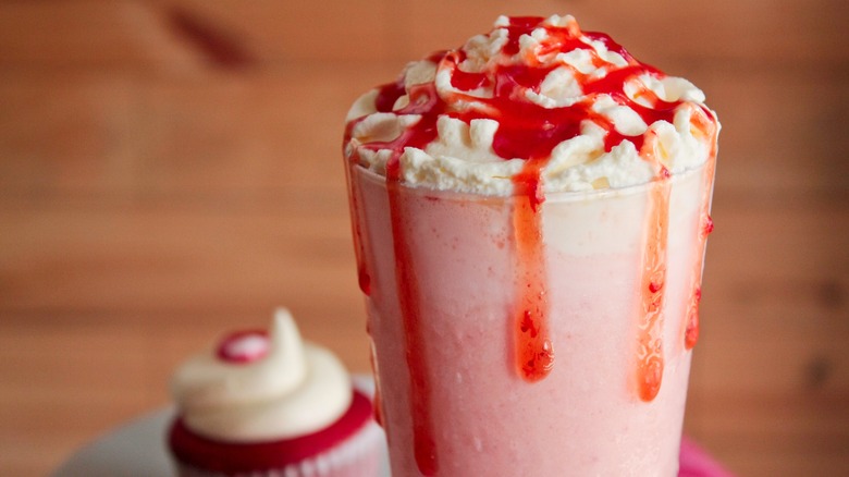 strawberry syrup topping a milkshake