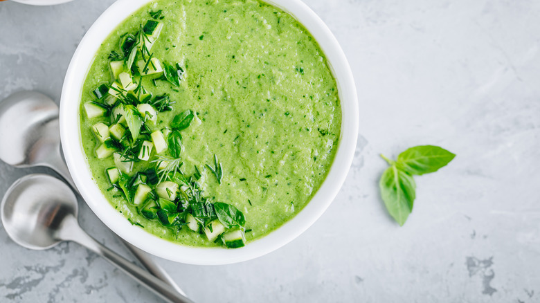 Green cucumber gazpacho in white bowl