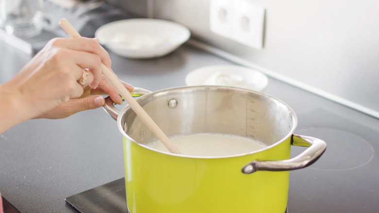 Woman mixing hot cream