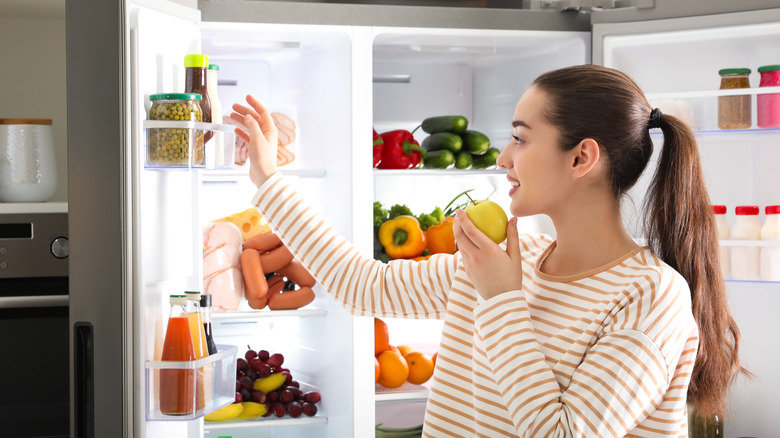 Woman looking in refrigerator