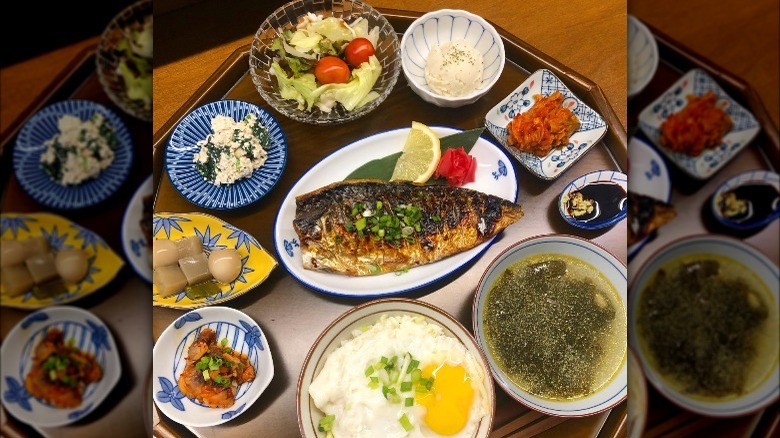 Grilled fish on a platter with side dishes