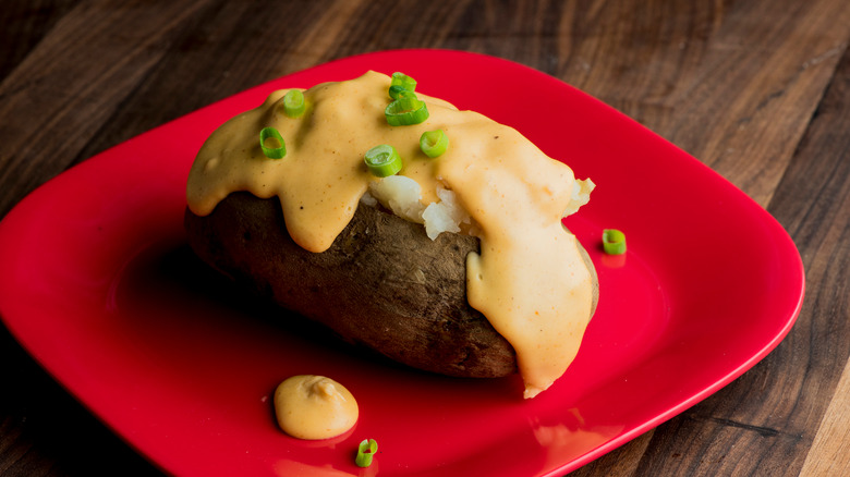 Baked potato on red plate