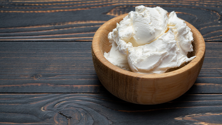 Mascarpone cheese in wooden bowl